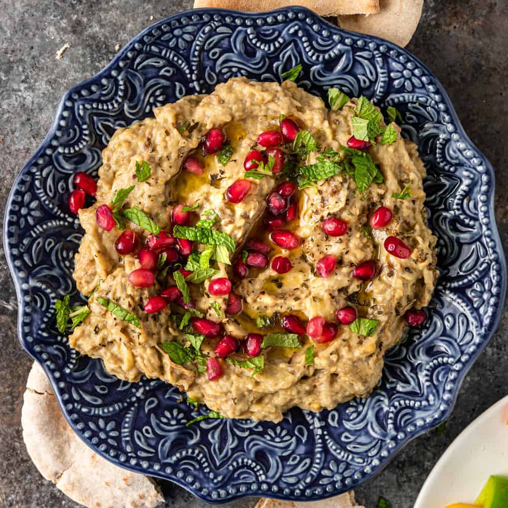 bowl of Middle Eastern mutabal dip garnished with pomegranate arils