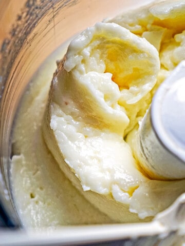 close up of lebanese garlic sauce in a food processor