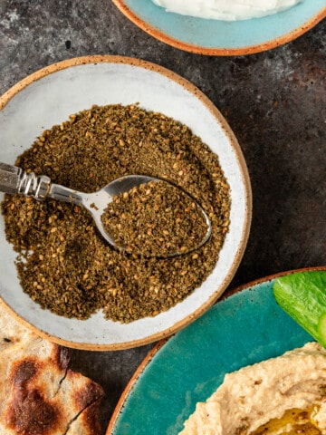 Lebanese za'atar spice blend with spoon in white dish