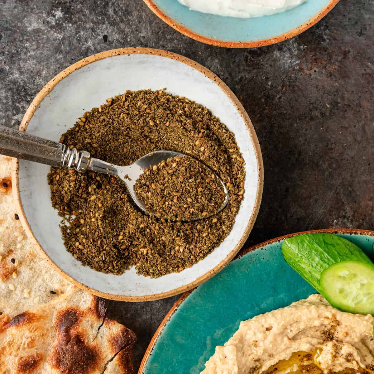 za'atar spices with spoon in white dish