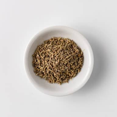 anise seeds in small white bowl