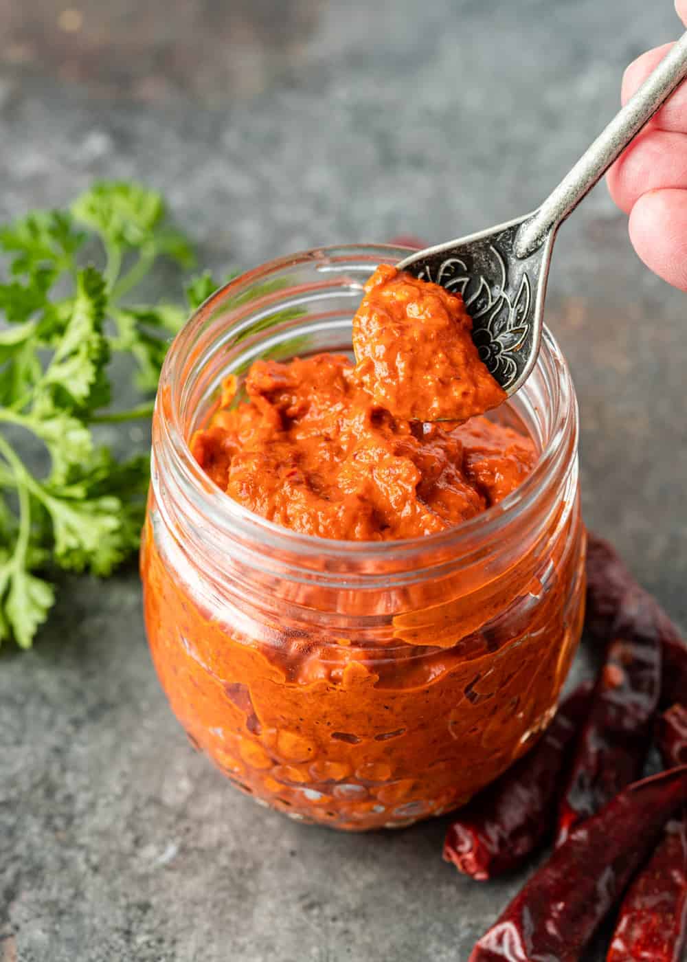 spoonful of red chili paste over jar