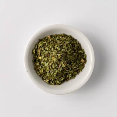 dried mint leaves in small white bowl