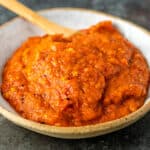 Serbian ajvar relish in white bowl with serving spoon