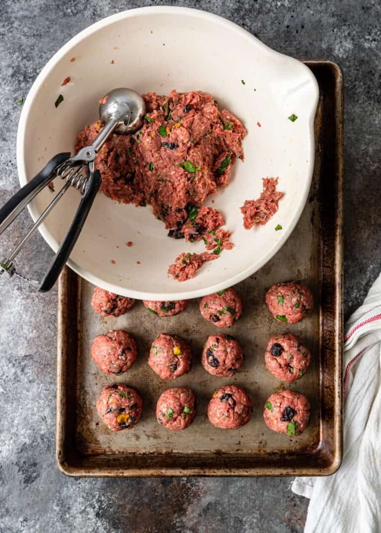 scooping ground meat mixture from a bowl p to make Persian meatball recipe