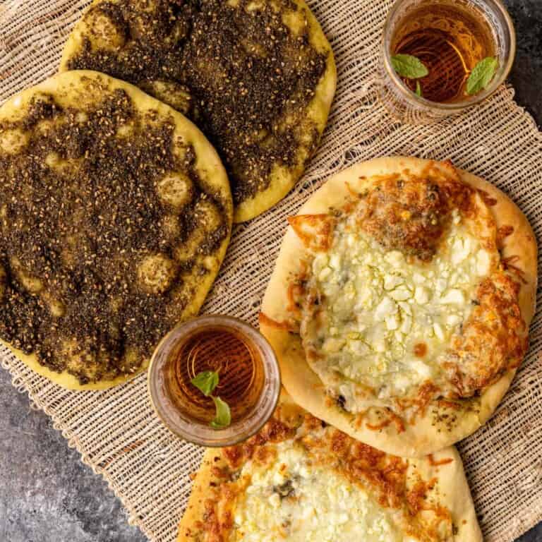 4 pieces of zaatar bread on beige woven placemat