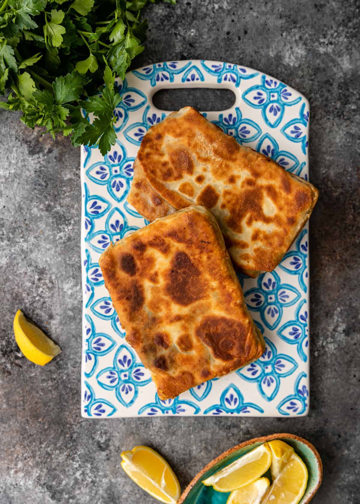 overhead: gozleme flatbreads on decorative blue and white flowered serving board