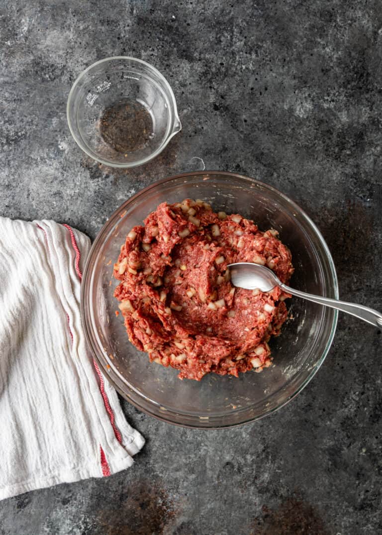overhead: raw ground meat filling in glass mixing bowl for gozleme recipe