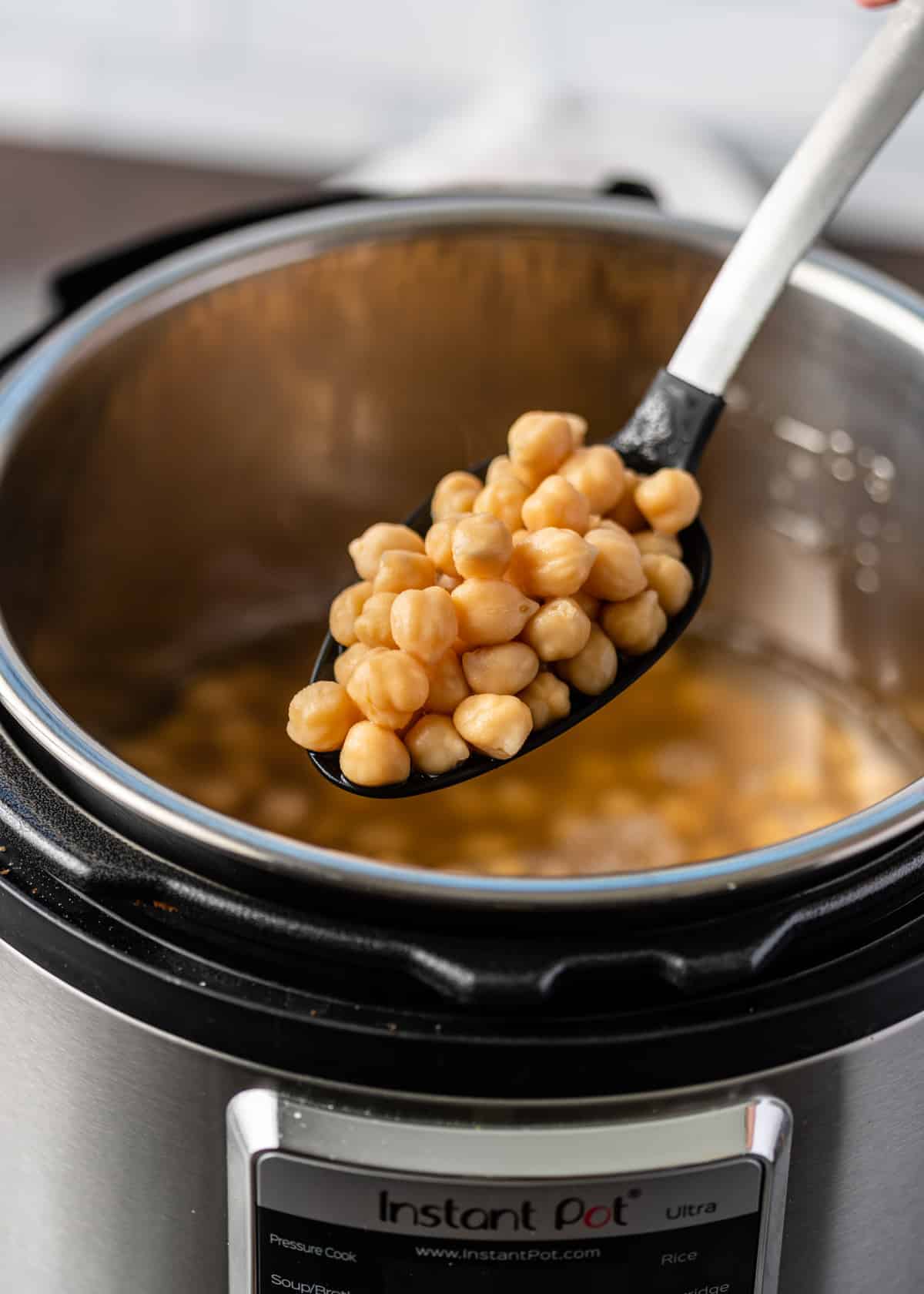 Instant Pot garbanzo beans on large serving spoon