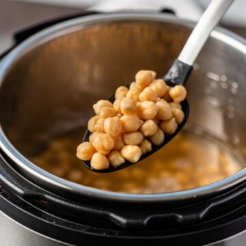 Instant Pot chickpeas on slotted spoon
