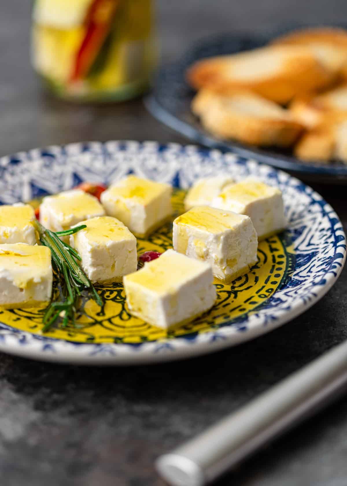 white marinated cheese cubes on small appetizer plate