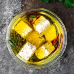 close up image: feta cheese appetizer in glass jar
