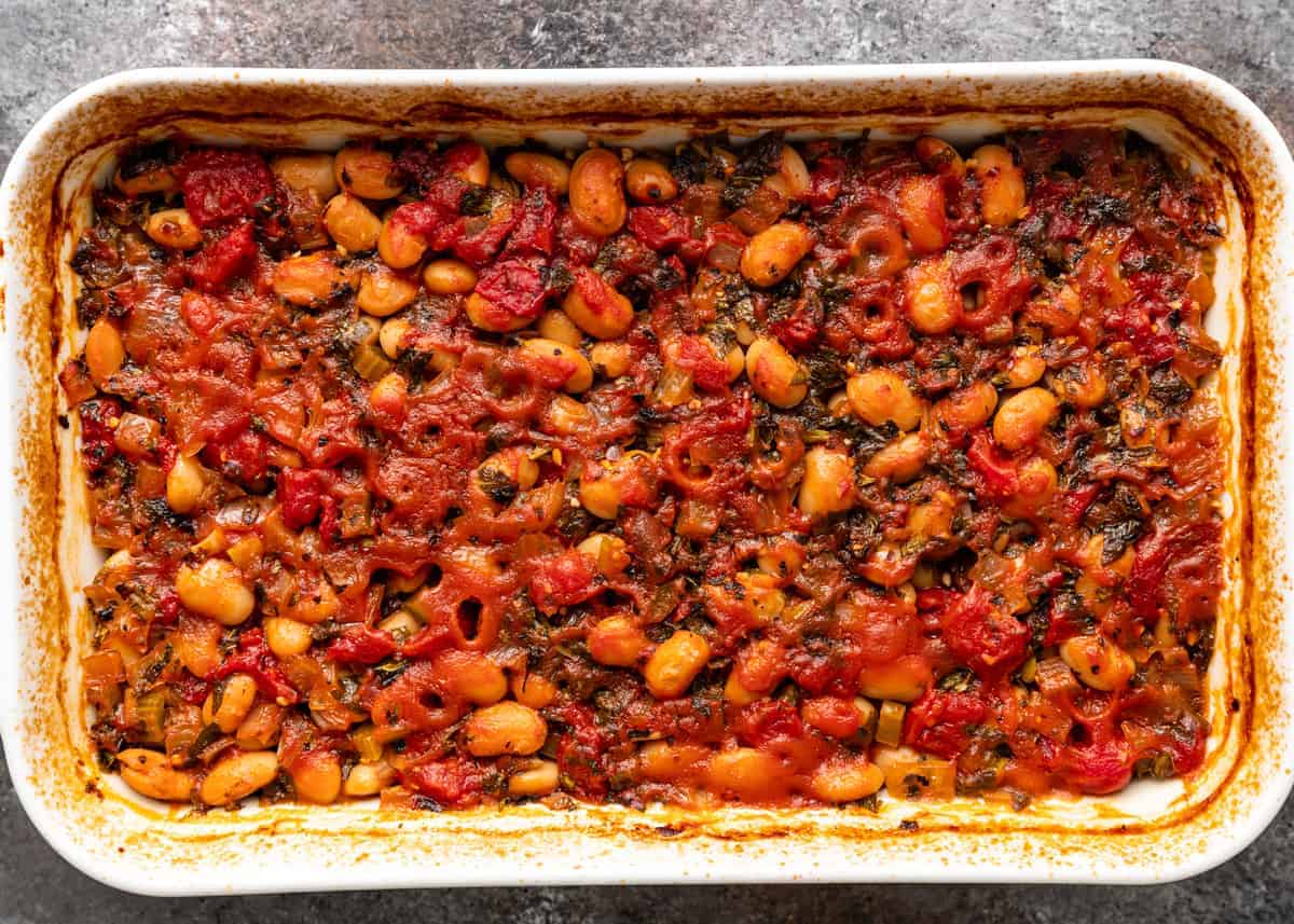 overhead image: side dish of baked legumes in tomato sauce