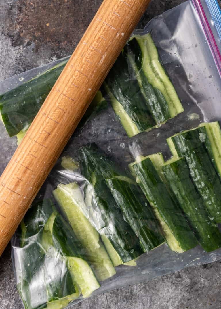 mashing cucumbers with a rolling pin for Asian salad