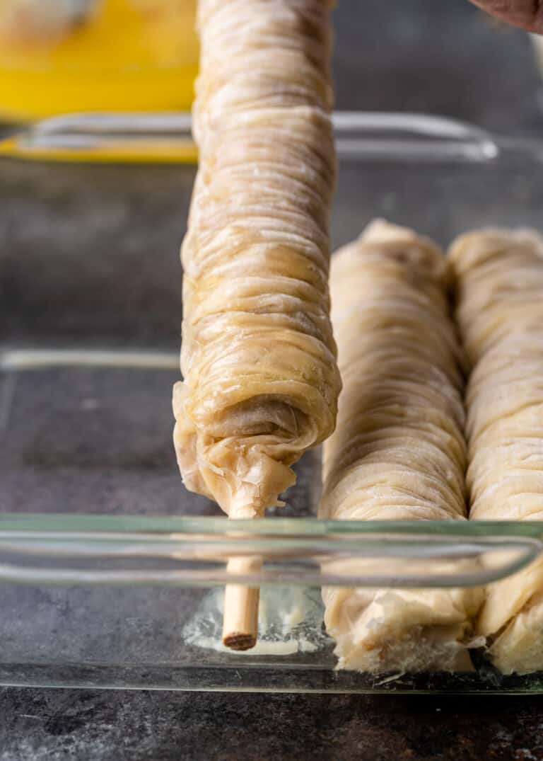 phyllo dough wrapped around wooden dowel for Turkish baklava