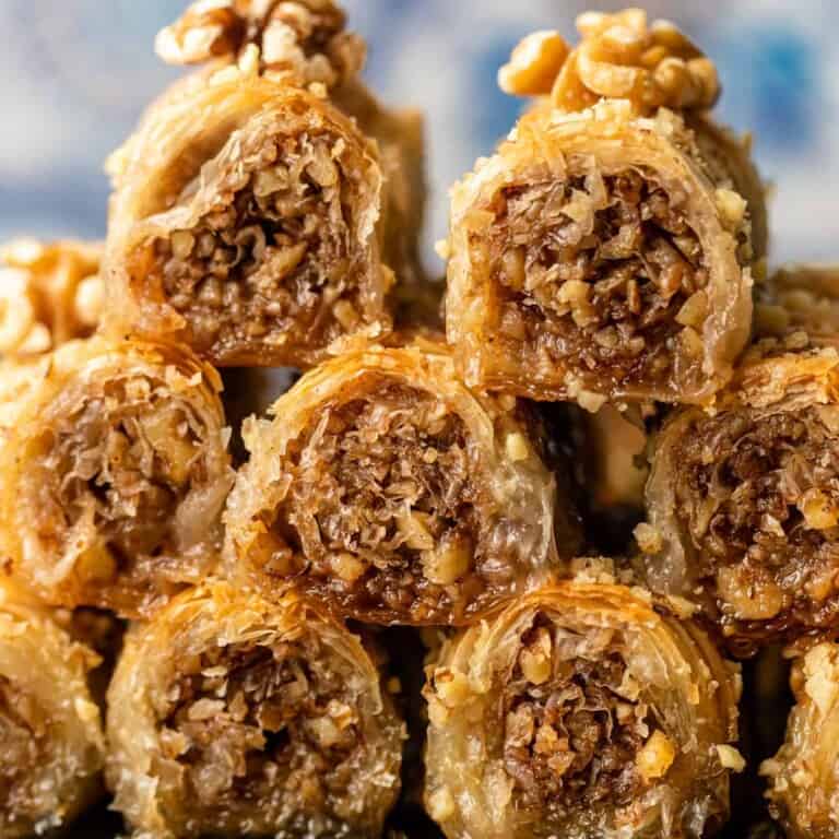 closeup: Greek baklava rolls with walnuts on top