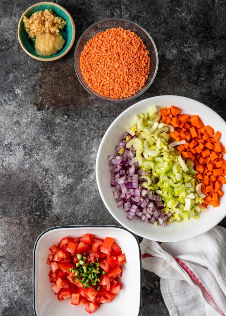 overhead: bowls of chopped vegetables and spices for turkey lentil soup recipe
