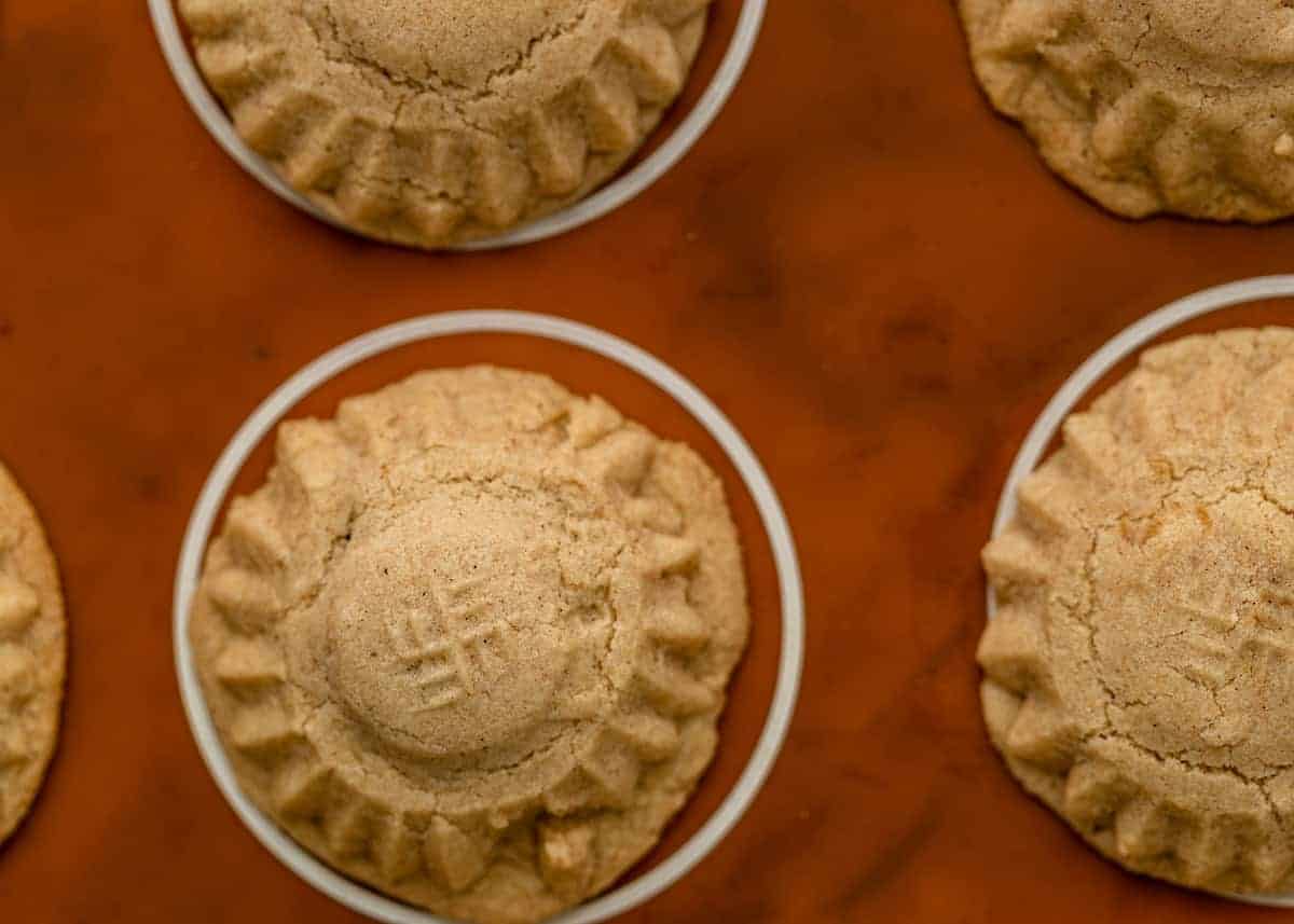 overhead closeup: tops of buttery stuffed cookies on baking sheet