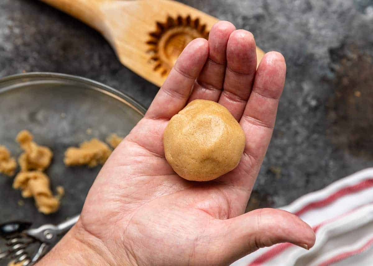 scoop of semolina cookie dough in palm of man's hand