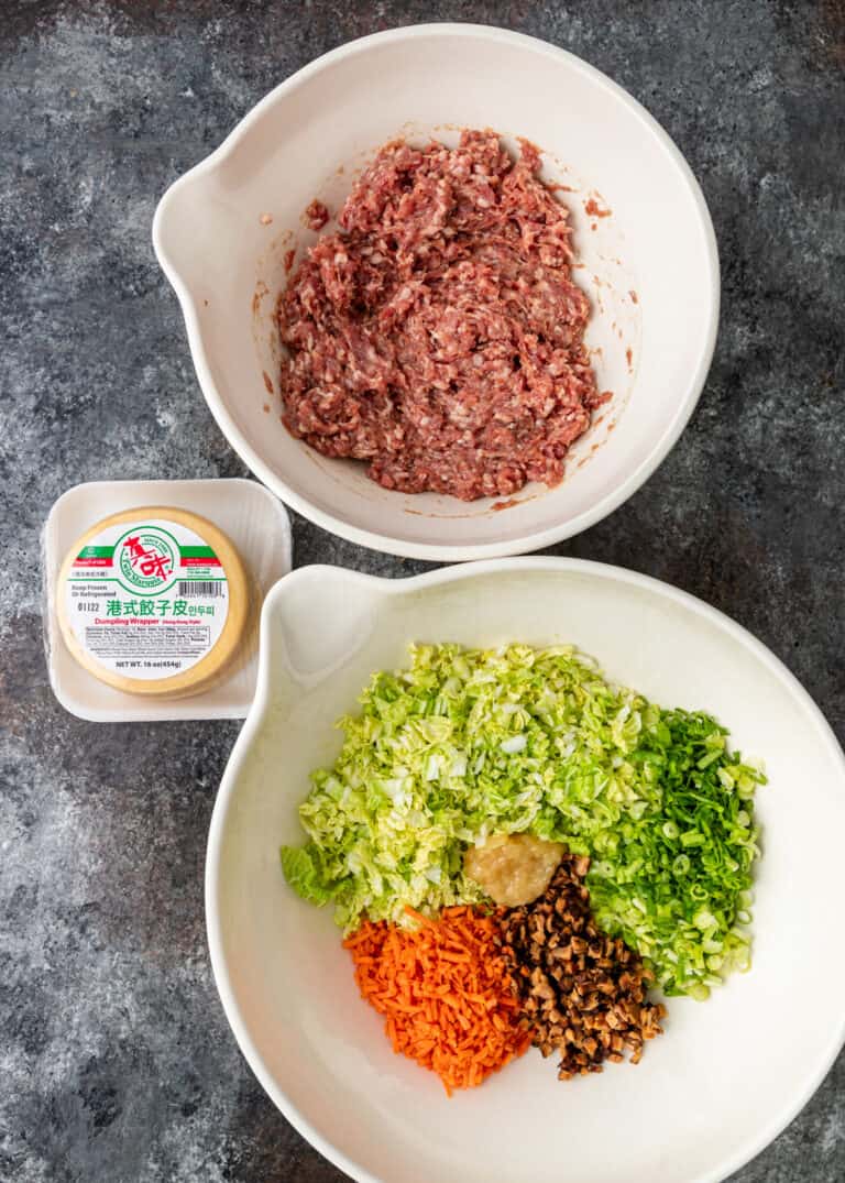 overhead: ground pork and vegetables in bowls to make potstickers recipe