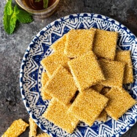 overhead: square of sesame snaps on blue and white plate