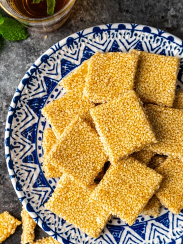 overhead: square of sesame snaps on blue and white plate