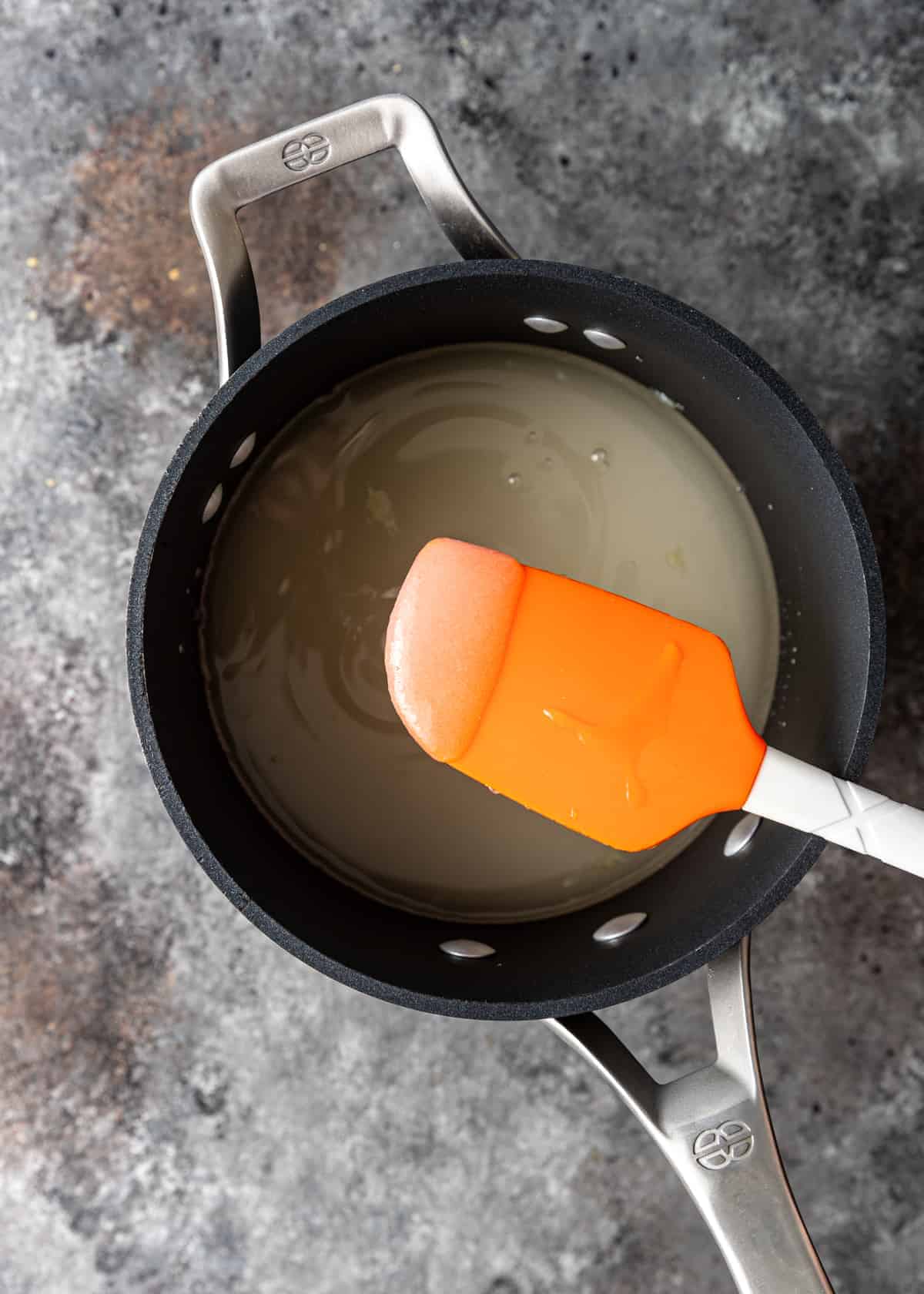 sugar melting with water in saucepan
