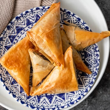 greek spinach pie phyllo appetizers on blue and white plate