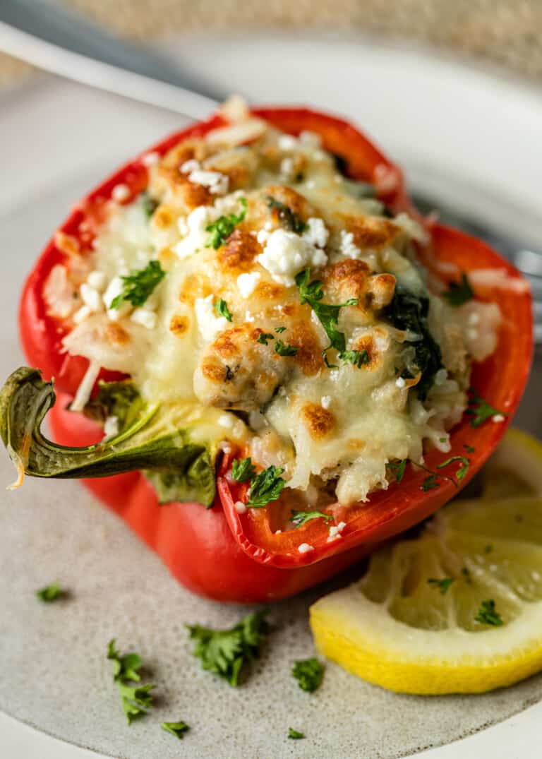 overhead: half a red pepper filled with cooked ground chicken, spinach and melted cheese