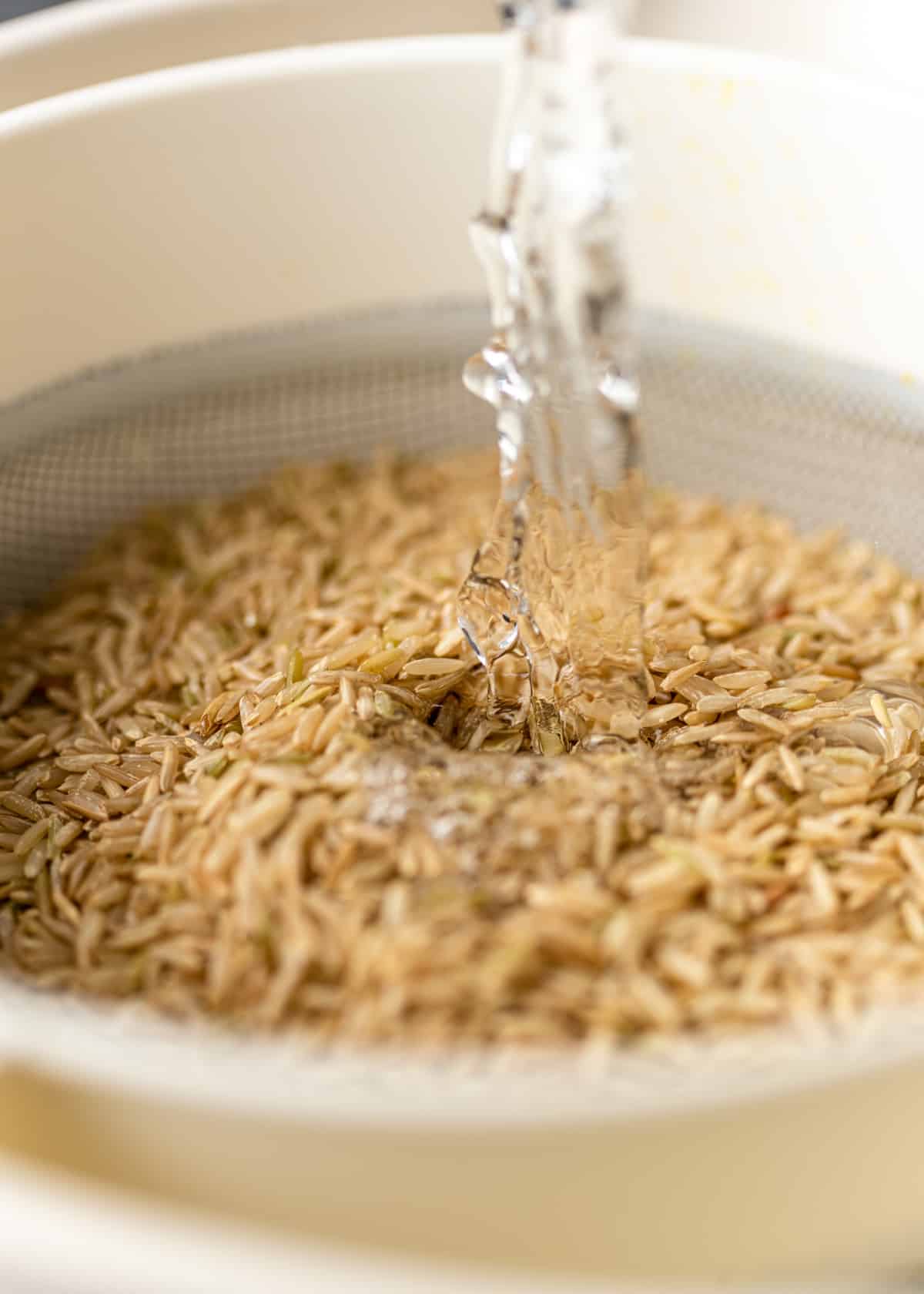 rinsing brown basmati rice in strainer