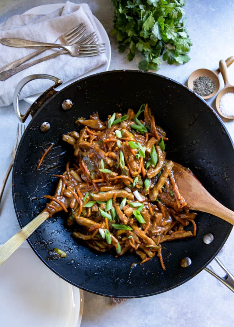overhead: making pork stir fry recipe in wok