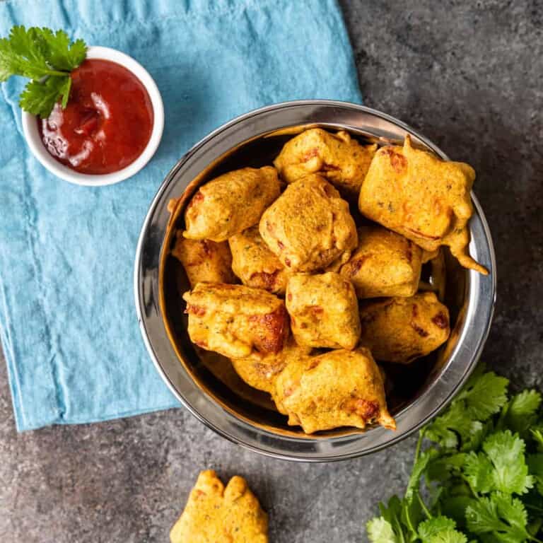 overhead: platter of paneer pakora with red dipping sauce