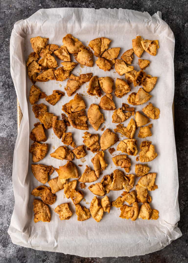 pieces of crispy pita on parchment lined baking sheet