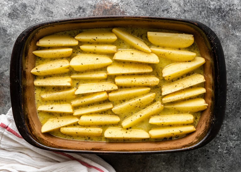 overhead: marinated potato wedges in baking pan