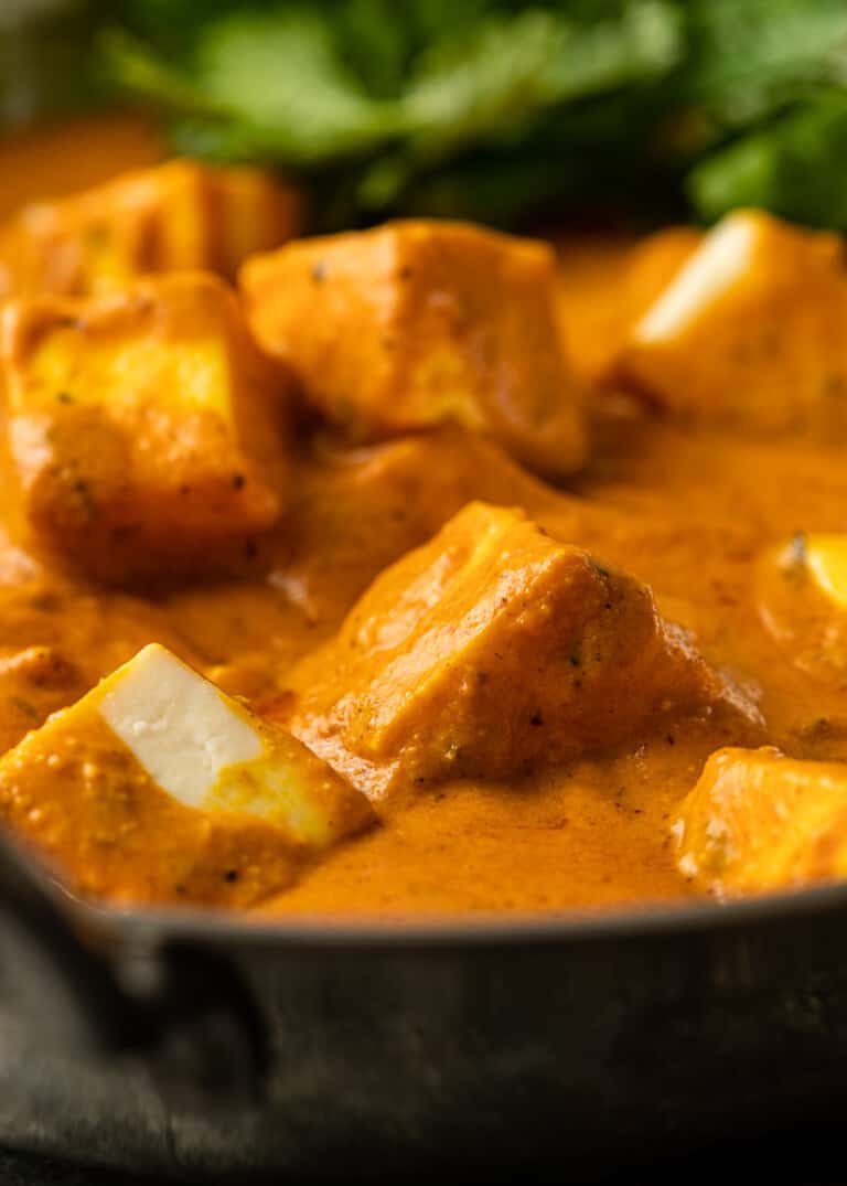 close up: pieces of paneer cheese in spicy gravy