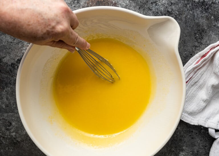 stirring eggs, sugar and oil in bowl