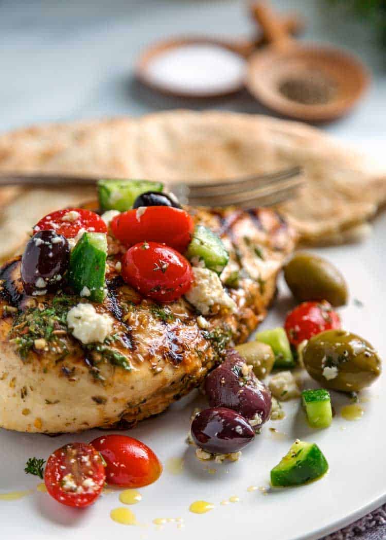 Mediterranean Grilled Chicken on a plate with tomatoes and olives