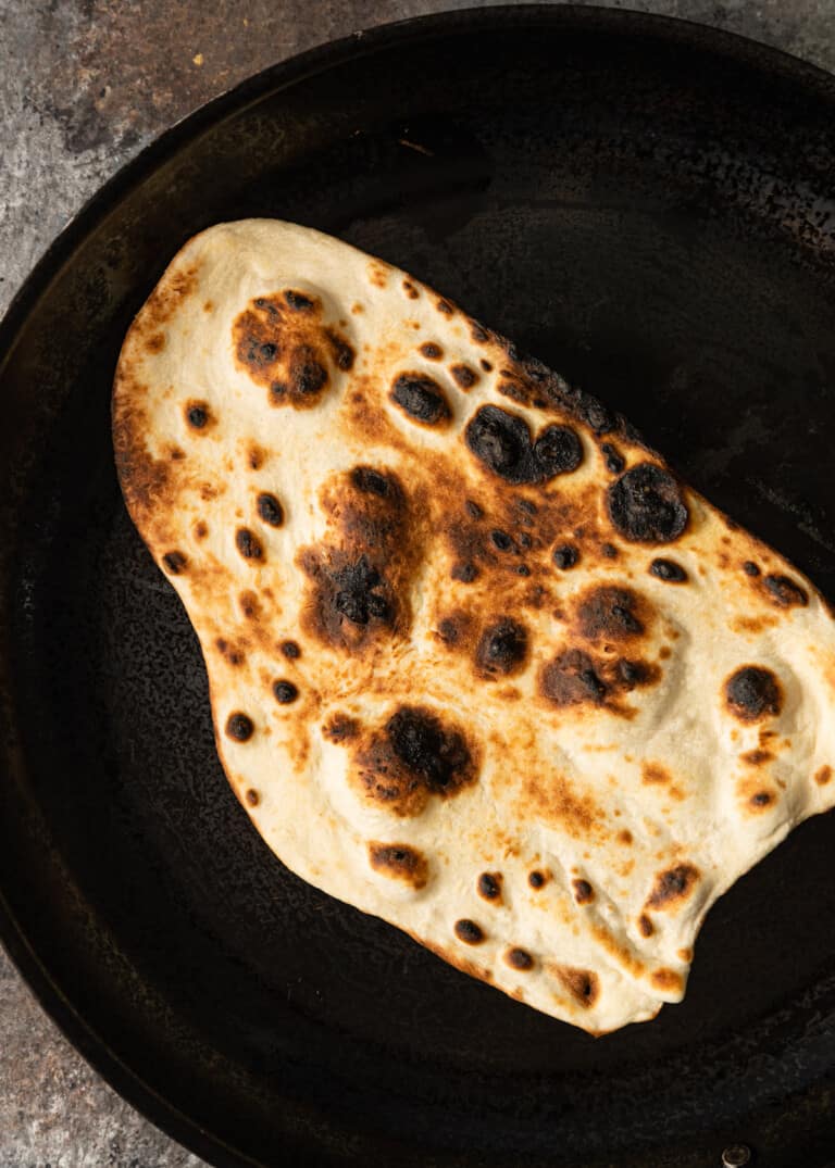 charred naan in skillet
