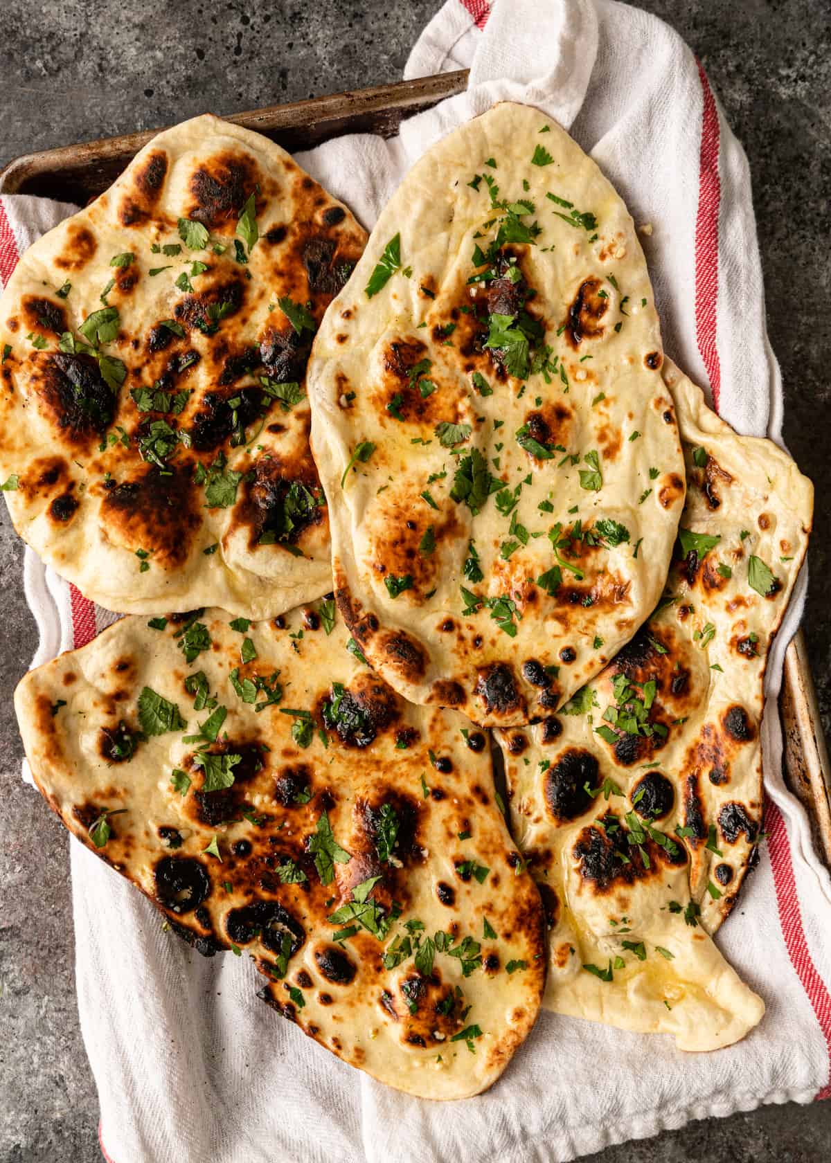 overhead: garlic naan recipe with cilantro on tray