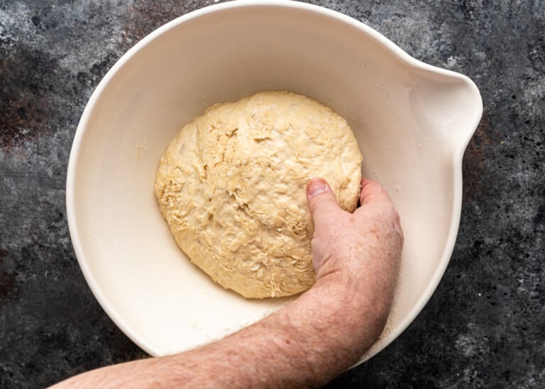 hand picking up dough ball