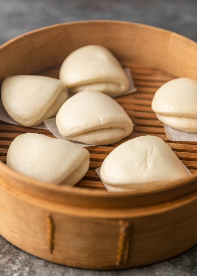 several bao buns inside of a container