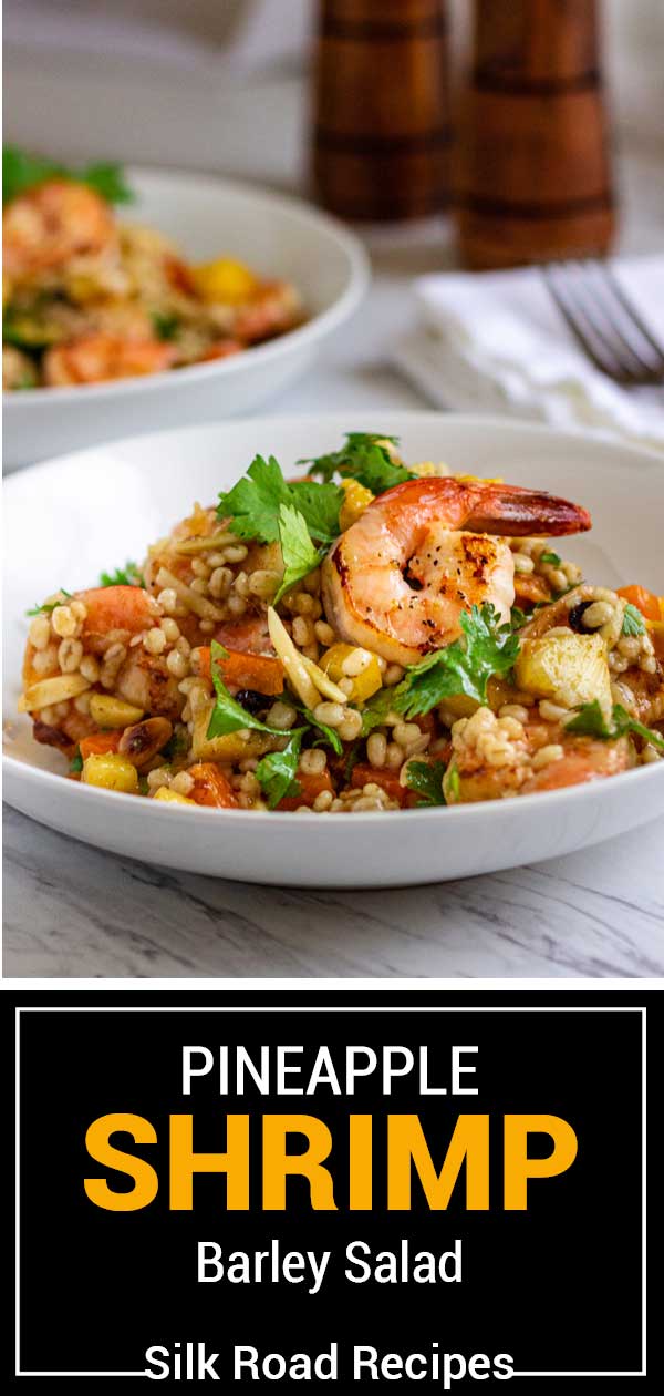 side view of a dish with barley salad and pineapple shrimp