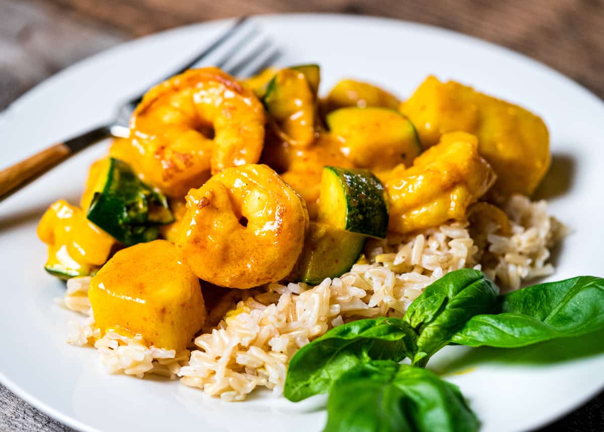 side view of thai yellow shrimp curry on plate
