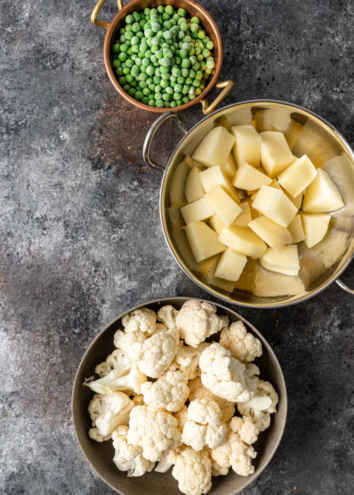potatoes, cauliflower, and peas in bowls