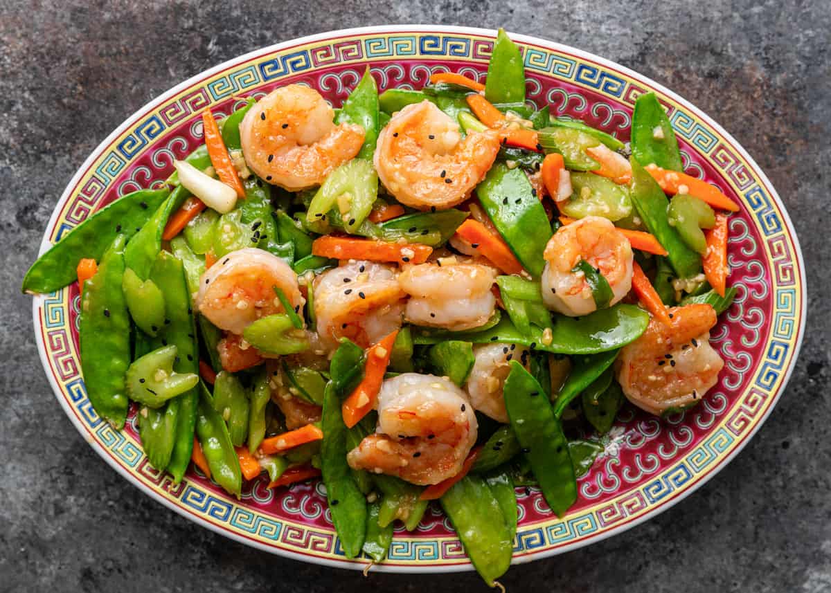 platter filled with snow peas and shrimp