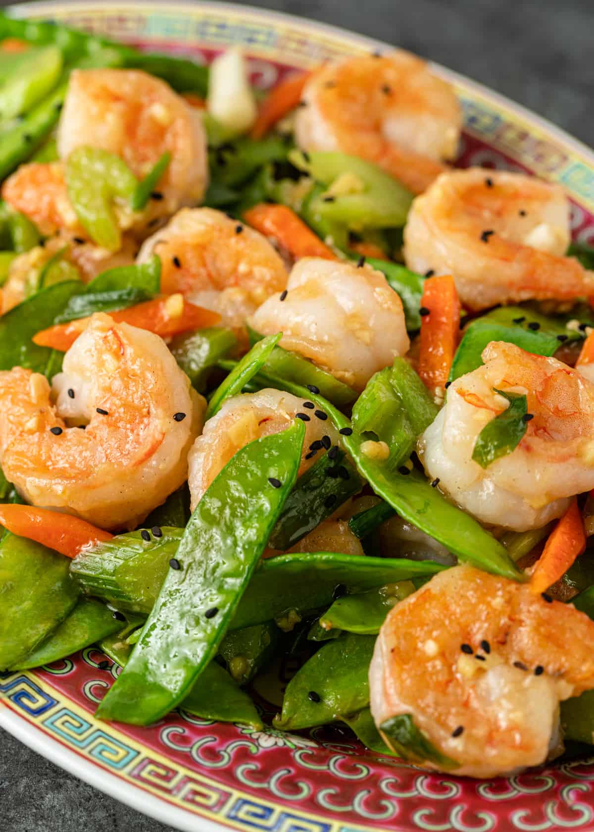 side view of a platter with shrimp and snow peas