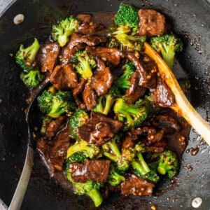 broccoli beef in wok with spoon