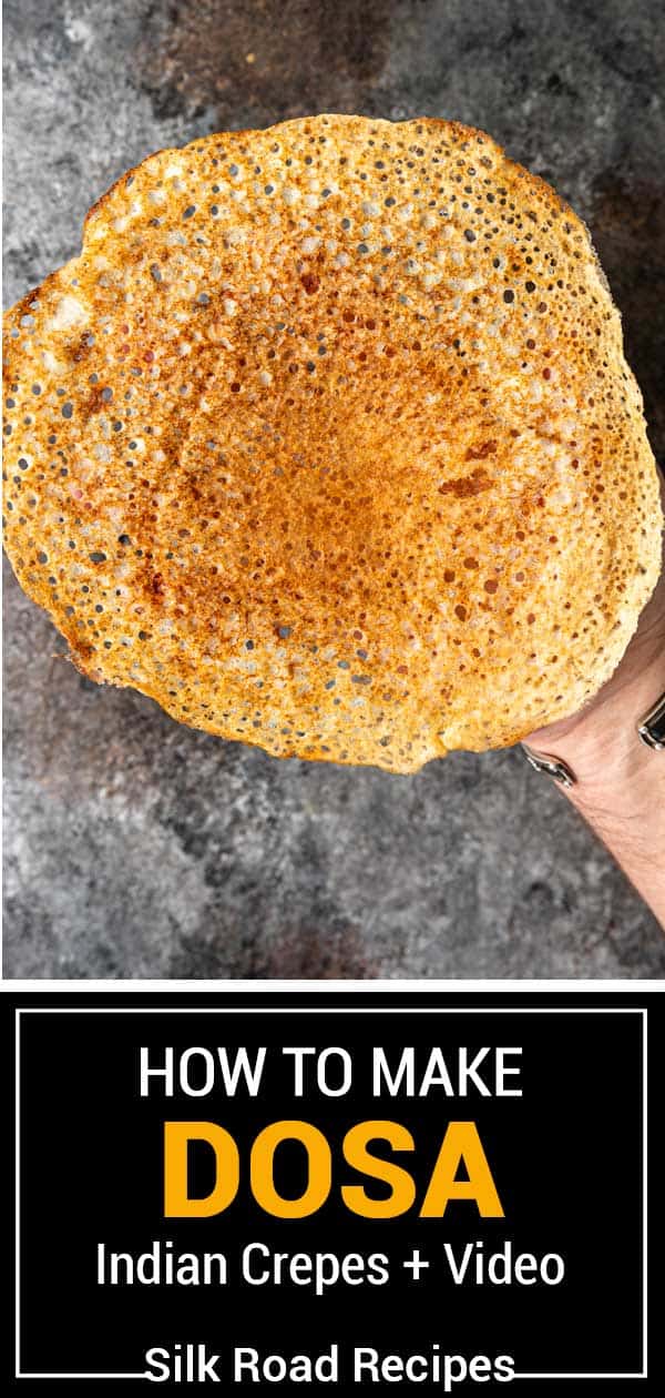 large dosa being held by a hand