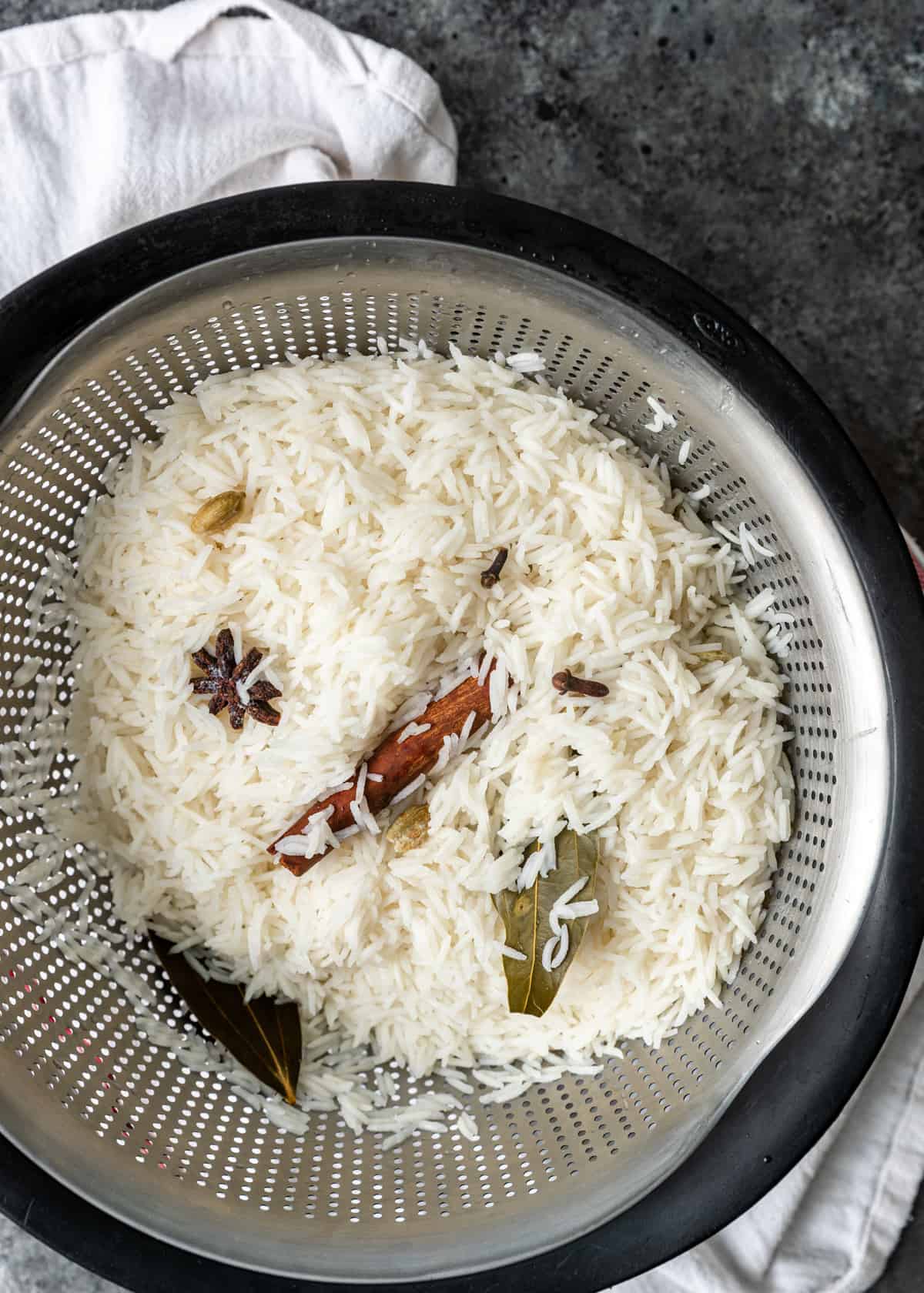 cooked rice in a colander 