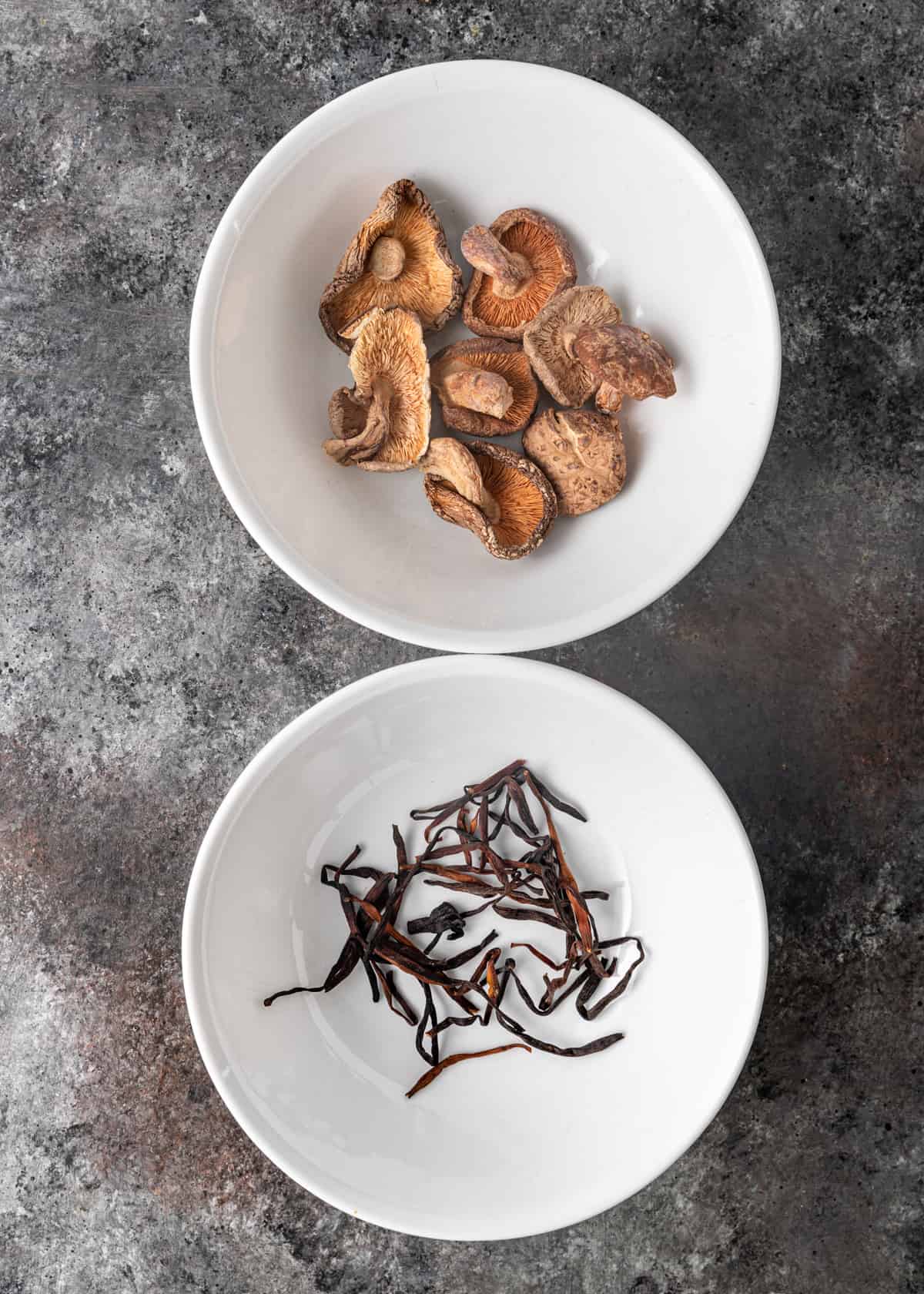 dried mushrooms and lily flowers in white bowls